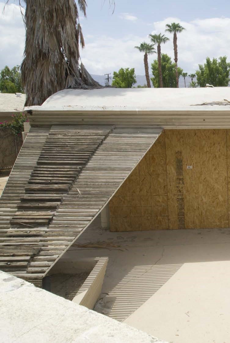 Wood trellis extending from southern side of the roof to concrete planter